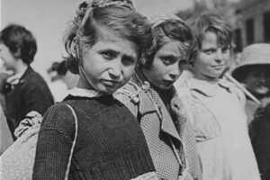Three Jewish refugee girls wait prior to their departure from Iran as part of the Tehran children’s transport. US Holocaust Memorial Museum, courtesy of David Laor
